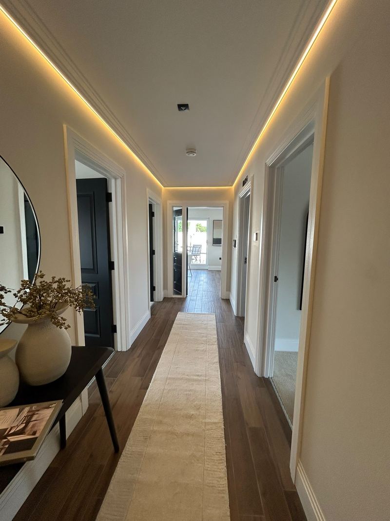 Finished apartment corridor with LED cove lighting at Oakfield House, Dorridge